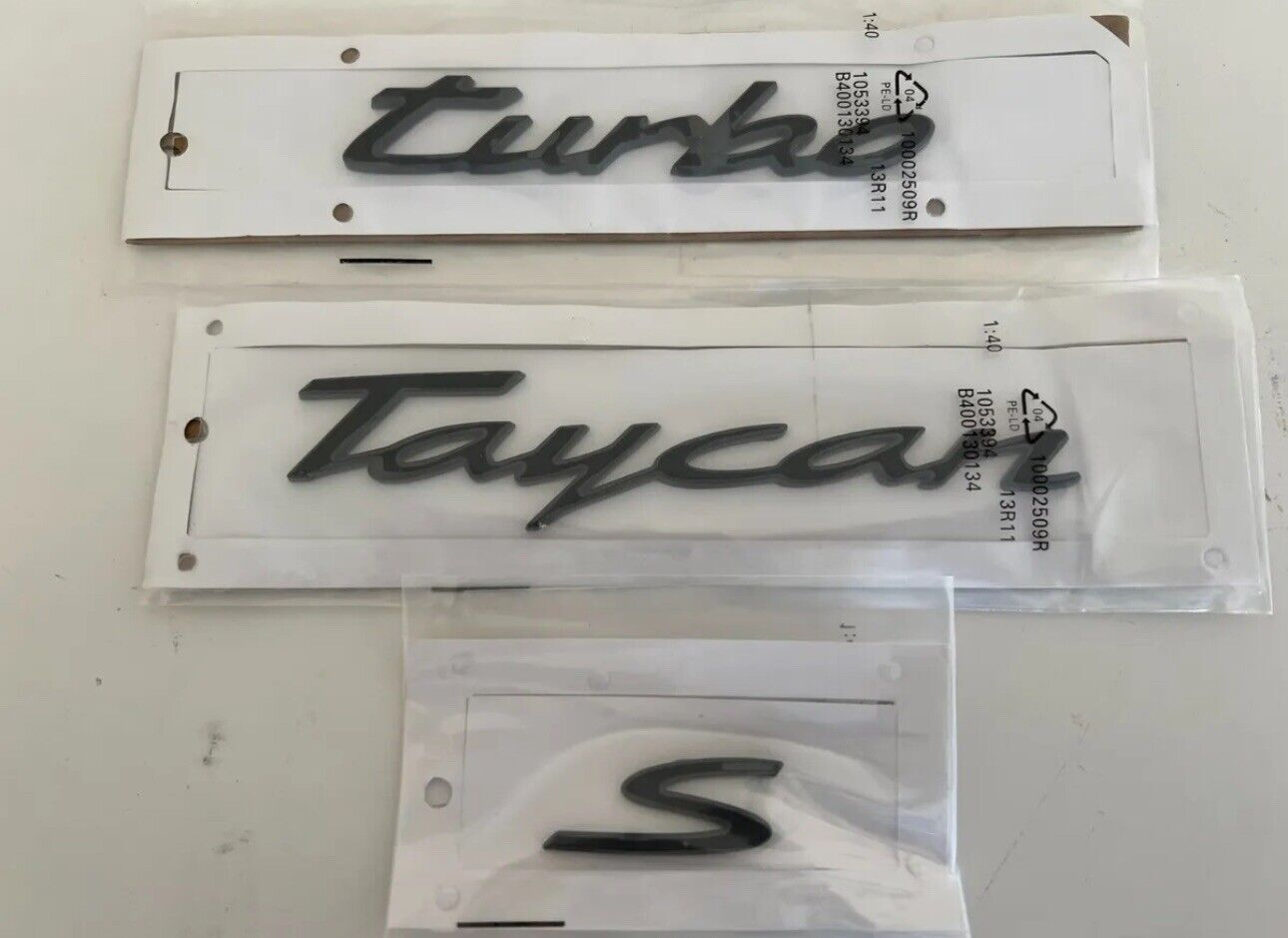 Porsche Taycan Turbo S gloss black rear emblems