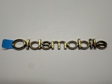 Genuine GM Oldsmobile gold Nameplate 10342809 picture