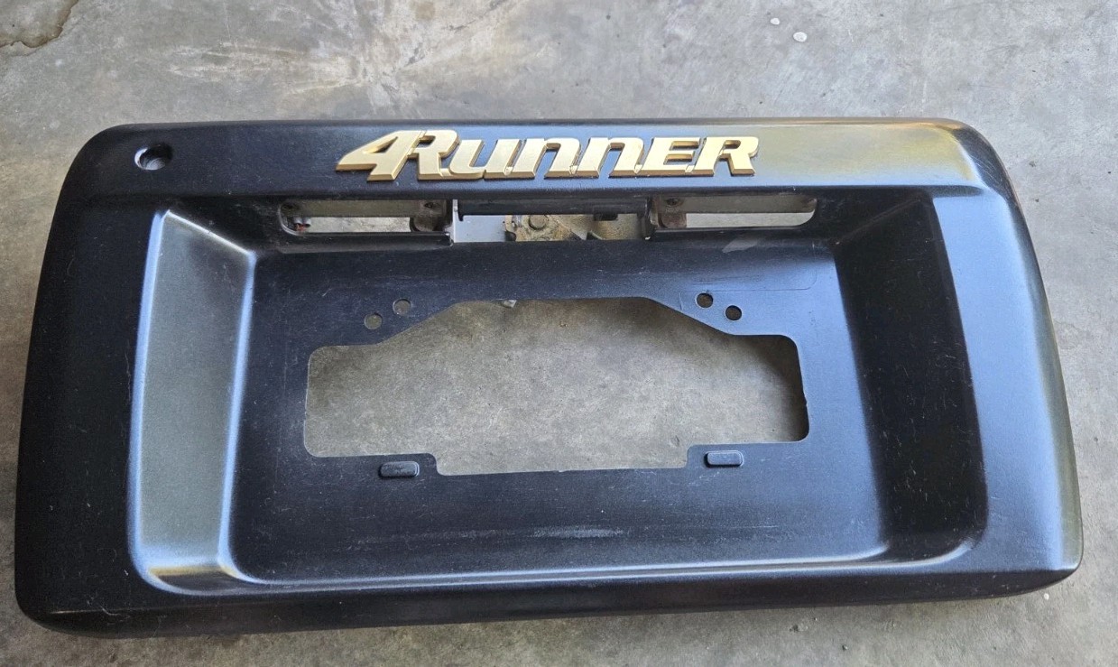 1996-2002 TOYOTA 4RUNNER REAR HATCH LICENSE PLATE HOLDER PANEL GOLD EMBLEM OEM.
