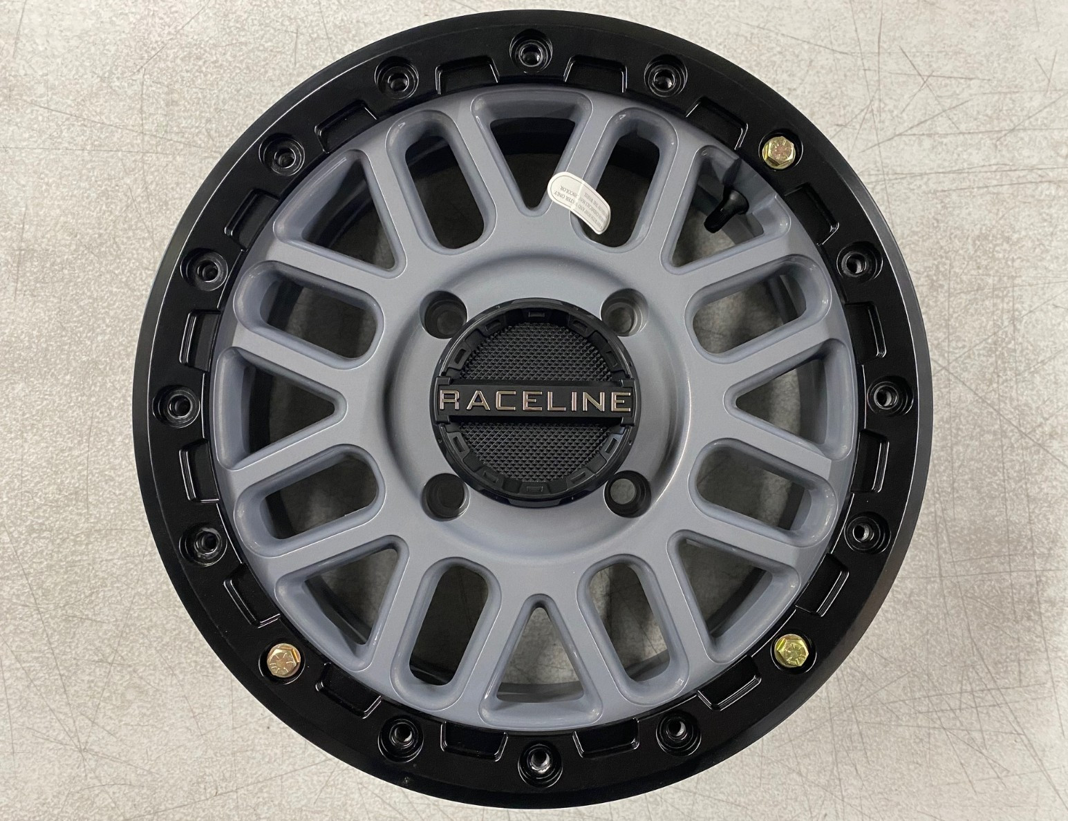 RACELINE PODIUM BDLK WHEEL 15X6 4/137 5+1 (+40MM) STEALTH GREY, 570-1655