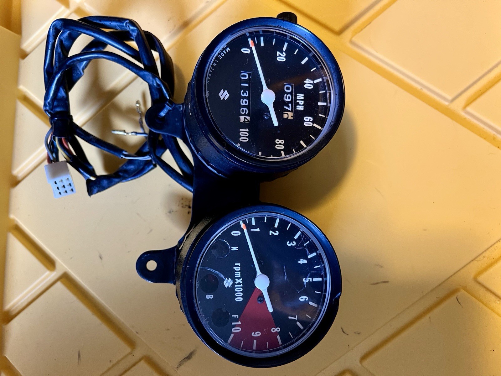 Suzuki TC 125 OEM speedometer and tachometer and mounting bracket very good cond
