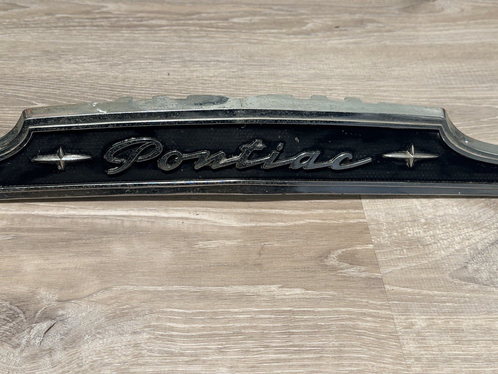 vintage 1951–1953 Pontiac hood grille emblem and trim nameplate