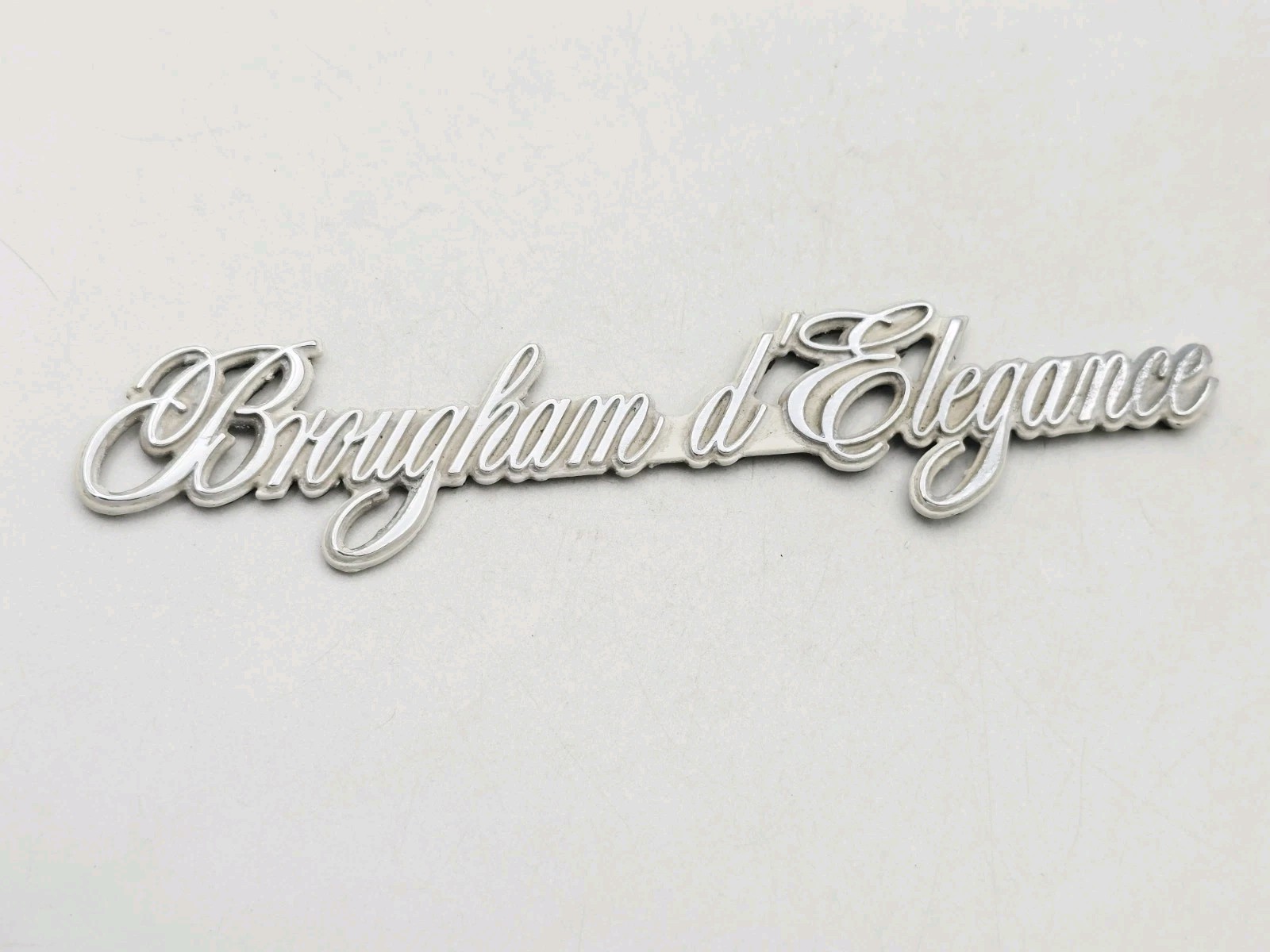 1980-1990 CADILLAC BROUGHAM ELEGANCE METAL VINTAGE LOGO BADGE EMBLEM 1980-1990 CADILLAC BROUGHAM ELEGANCE METAL VINTAGE LOGO BADGE EMBLEM