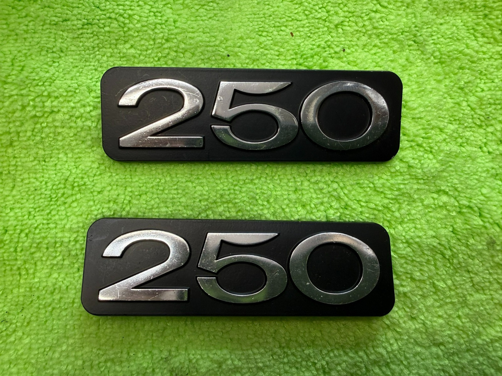 Suzuki 250 OEM NOS sidecover badge Suzuki 250 OEM NOS sidecover badge