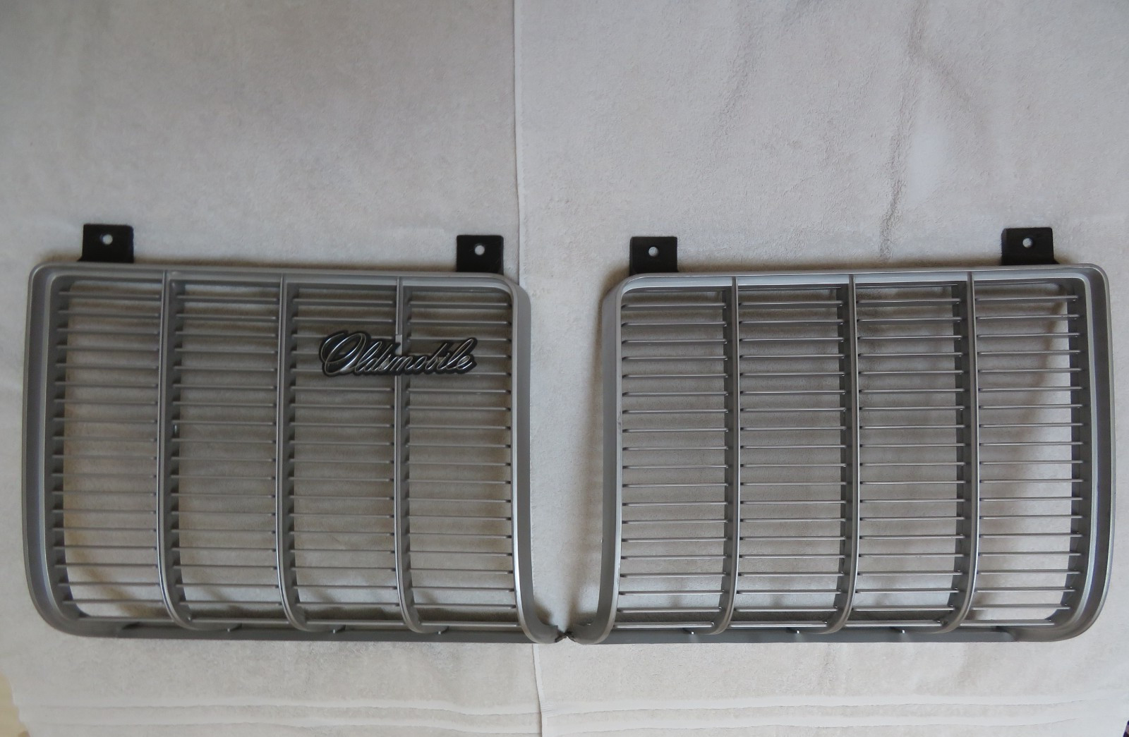 NOS 1973 GM Oldsmobile Cutlass S LH and RH Grilles Model #s 412988 412989