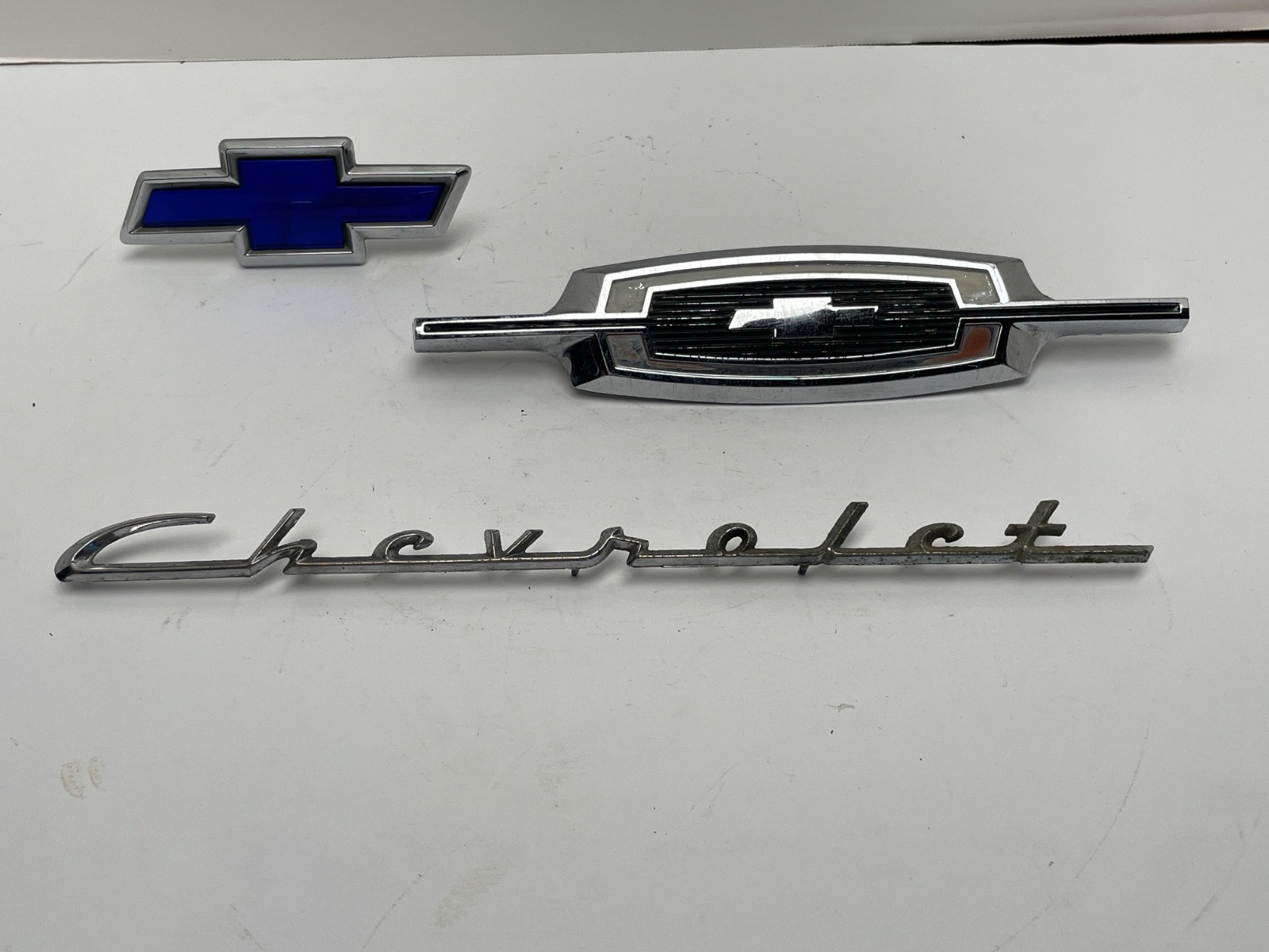 THREE VINTAGE CHEVROLET / CHEVY EMBLEMS / BADGES