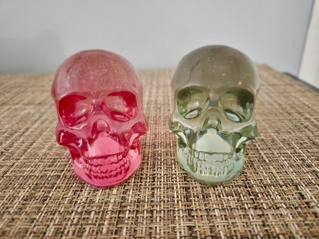 Two Small Skulls, Like Glass, One Smokey Clear, One Red Decorations