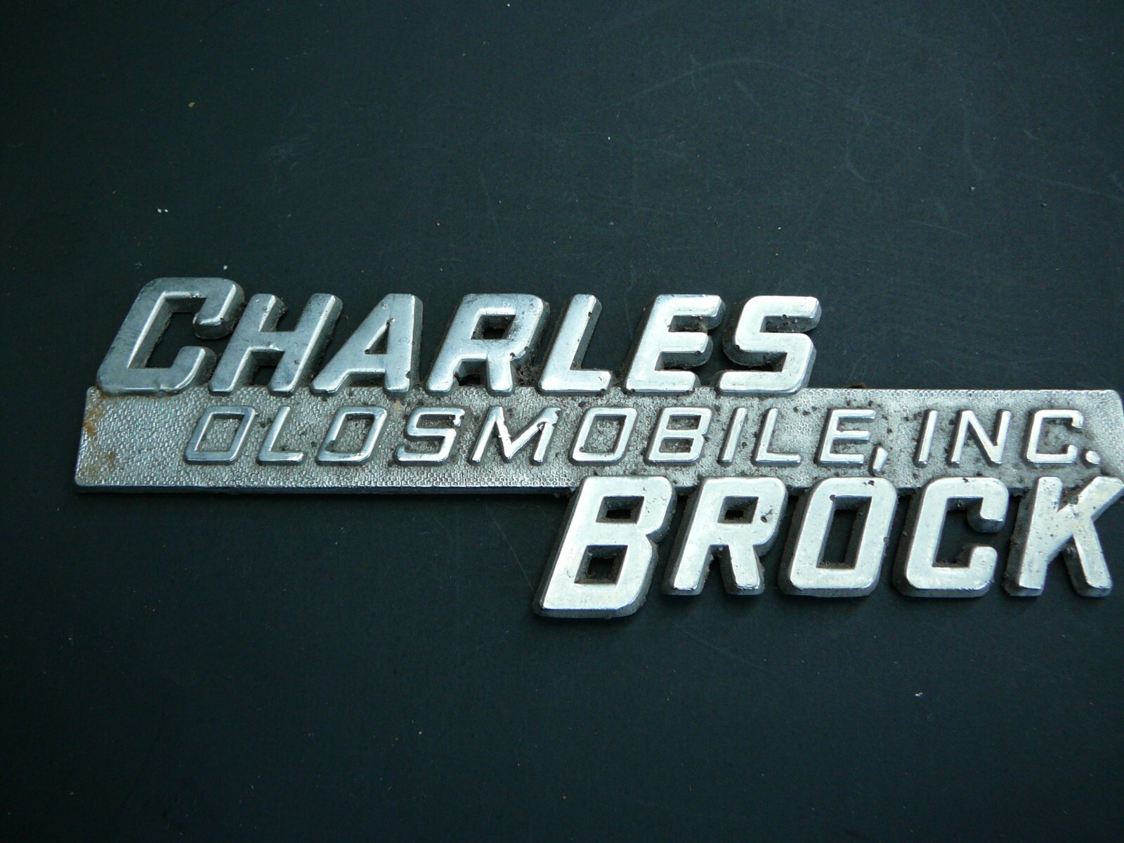 Vintage CHARLES BROCK OLDSMOBILE, INC. Car Dealership Badge Emblem Vintage CHARLES BROCK OLDSMOBILE, INC. Car Dealership Badge Emblem