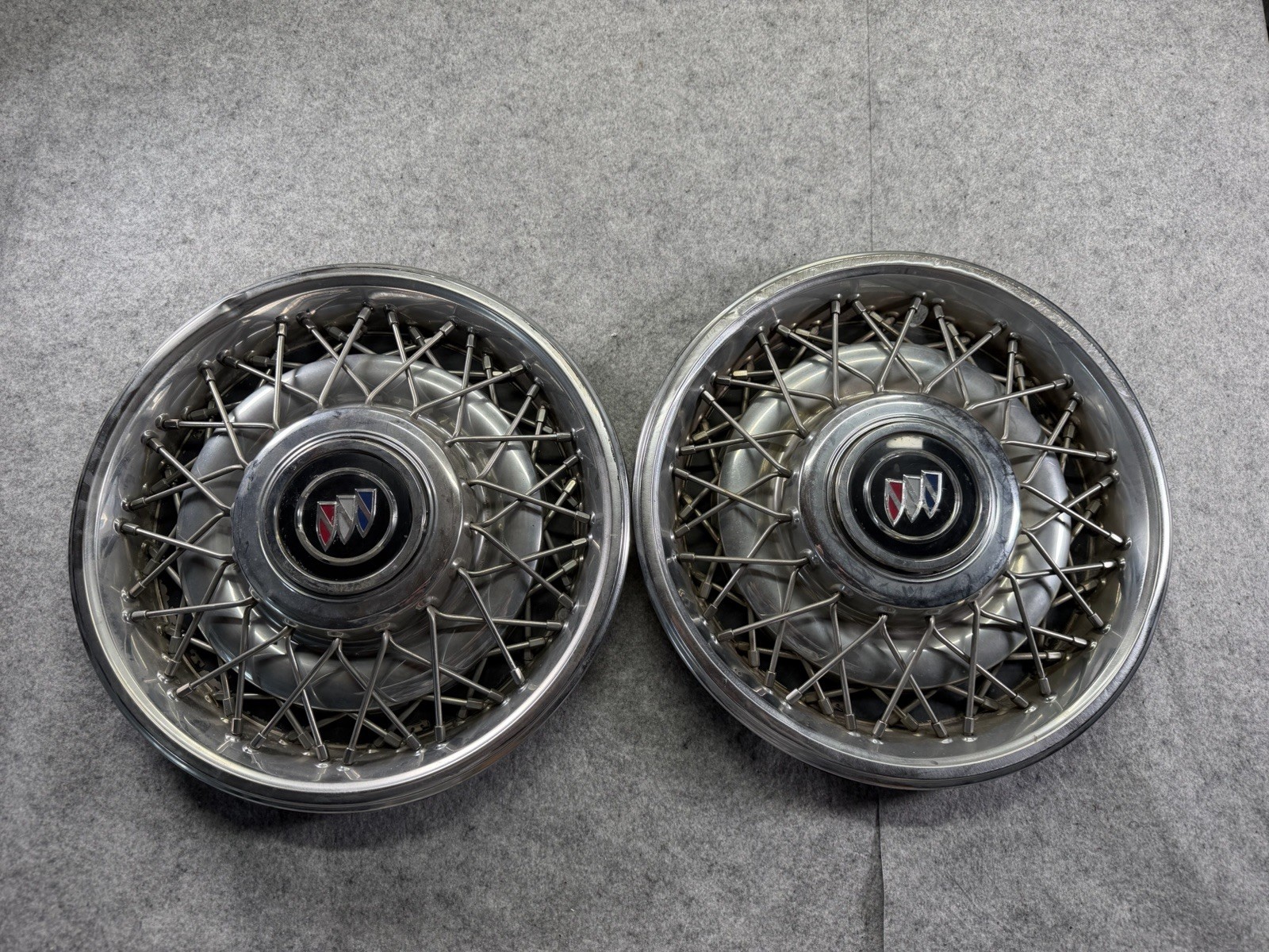 Two genuine 1991 1992 Buick Roadmaster 15 inch wire spoke hubcap And Center Caps